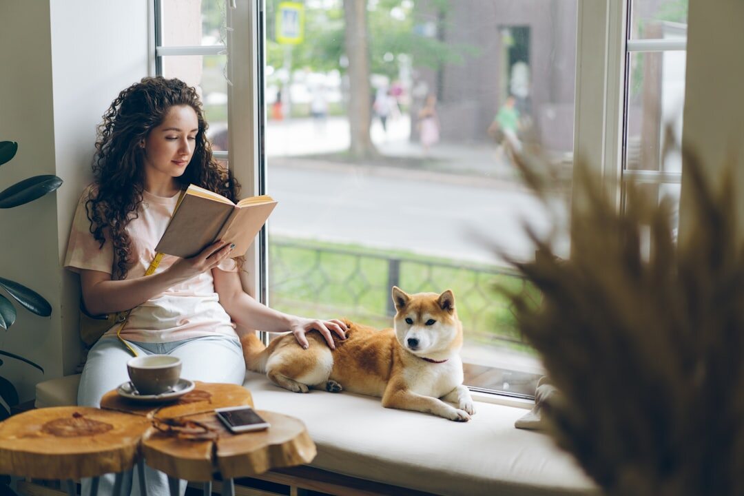 person reading book by window