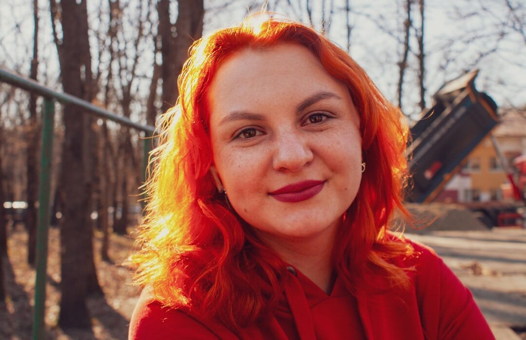 person smiling in sunny park