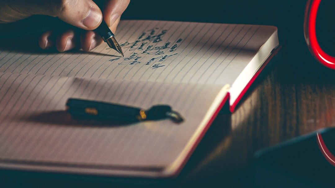 person writing in journal